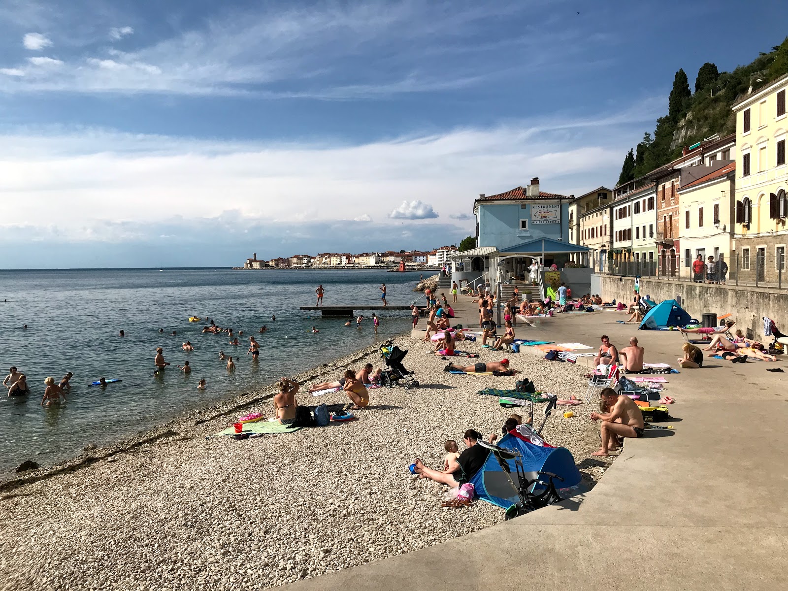 People enjoying a sunny beach day fornace Beach piran slovenia